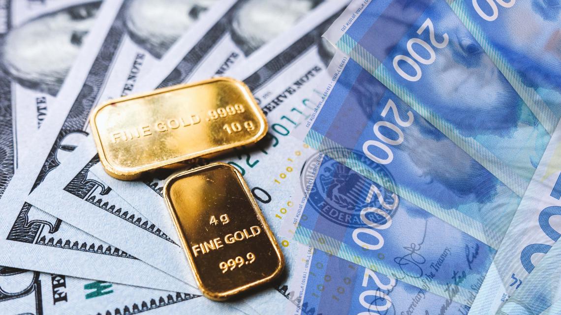 gold-bar-and-us-dollar-bills-2021-08-29-17-10-48-utc.jpg