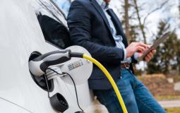 business-man-standing-near-charging-electric-car-o-2021-12-09-04-13-54-utc.jpg