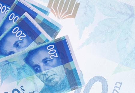 200-israeli-new-shekels-bills-lies-in-stack-on-bac-2021-08-30-04-33-31-utc.jpg