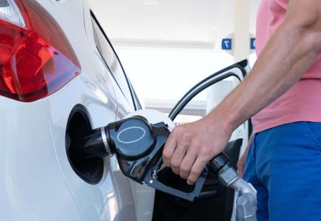 man-filling-gasoline-in-car-at-gas-station-2021-12-02-19-00-01-utc.jpg