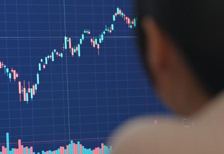 woman-work-on-computer-with-stock-market-at-home-2021-08-29-05-19-53-utc.jpg