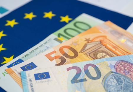 euro-banknote-on-eu-flag-2021-12-09-19-28-38-utc.jpg