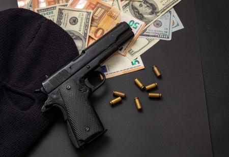 pistol-and-balaclava-on-dollar-and-euro-banknotes-2022-12-16-12-20-47-utc.jpeg