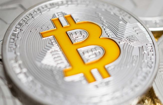 close-up-of-bitcoin-physical-coin-on-stack-of-many-2021-08-27-09-56-09-utc.jpg
