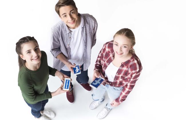 high-angle-view-of-teenage-friends-holding-smartph-2021-09-01-03-31-34-utc.jpg