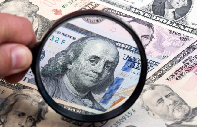 american-dollars-in-a-magnifying-glass-2021-08-29-07-37-46-utc.jpg