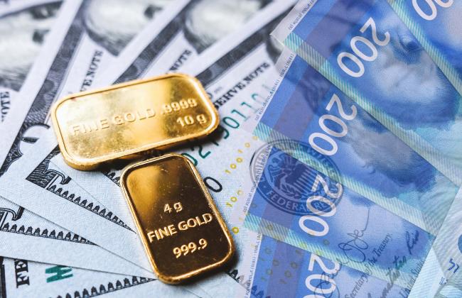 gold-bar-and-us-dollar-bills-2021-08-29-17-10-48-utc.jpg